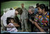 President George W. Bush and Mrs. Laura Bush play with a young girl during a visit Monday, March 12, 2007, to the Carlos Emilio Leonardo School in Santata Cruz Balanya, Guatemala. The couple visited a medical readiness and training exercise site at the school. White House photo by Eric Draper