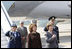 Mrs. Laura Bush holds her hand over her heart during the playing of the national anthem Wednesday, April 2, 2008, as she stands with Mrs. Maria Basescu, spouse of Romania's President Traian Basescu, on the red carpet during the arrival ceremony at Mihail Kogalniceanu Airport in Constanta, Romania.