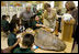 Laura Bush, listens to a student talk about Sea Turtles, Thursday, Feb. 16, 2006, as Fran Mainella, Director of the National Park Service, and Stella Summers, Teacher of the Gifted Science class, look on during a visit to Banyan Elementary School in Miami, FL, to support education about parks and the environment. White House photo by Shealah Craighead 