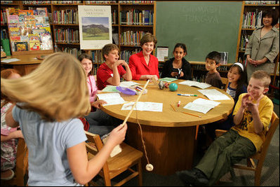 Mrs. Laura Bush watches a student play a ring toss game at Balboa Magnet Elementary School Wednesday, Feb. 28, 2007, in Northridge, Calif., as they participate in Junior Ranger activities. The National Park Service Junior Ranger program provides activities in parks and partnering schools to teach young people about America's National Parks. White House photo by Shealah Craighead 