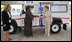 Mrs. Laura Bush and Mrs. Salma Kikwete, First Lady of Tanzania, exchange handshakes after Mrs. Bush presented Mrs. Kikwete with keys to an ambulance Sunday, Feb. 17, 2008, during her visit to Dar es Salaam. The ambulance will be donated to Sokoine Regional Hospital and will be used in the Lindi Region, one of the poorest and neediest in the country. The donation was a result of a joint visit to the hospital by Mrs. Kikwete and Pam White, left, USAID Mission Director.