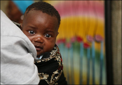 A young Tanzanian child is awed by the camera during a visit by Mrs. Laura Bush Sunday, Feb. 17, 2008, to the WAMA Foundation in Dar es Salaam. The foundation is a non-profit organization founded by Salma Kikwete, First Lady of Tanzania, with a focus on development by improving women’s social and economic status by redefining gender roles and creating more opportunities for the development of women and children.