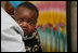 A young Tanzanian child is awed by the camera during a visit by Mrs. Laura Bush Sunday, Feb. 17, 2008, to the WAMA Foundation in Dar es Salaam. The foundation is a non-profit organization founded by Salma Kikwete, First Lady of Tanzania, with a focus on development by improving women’s social and economic status by redefining gender roles and creating more opportunities for the development of women and children.