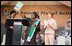 Mrs. Laura Bush applauds as Mrs. Salma Kikwete, First Lady of Tanzania, holds up the National Costed Plan of Action for Most Vulnerable Children, 2007-2010, supported both financially and technically by PEPFAR and UNICEF, during the visit by Mrs. Bush to the WAMA Foundation in Dar es Salaam.