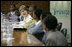 Mrs. Laura Bush joins Rwanda first lady Jeannette Kagame, center, as they listen to students during a forum Tuesday, Feb. 19, 2008 in Kigali, Rwanda, to promote girl's education.