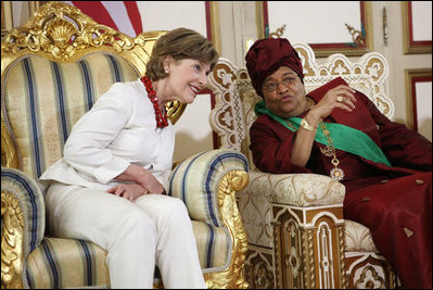 Mrs. Laura Bush listens to Liberian President Ellen Johnson-Sirleaf Thursday, February 21, 2008, in Monrovia, Liberia, during a gowning and investiture ceremony in honor of President Bush, Mrs. Bush and Secretary Condoleezza Rice.