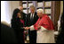 As President George W. Bush looks on, Mrs. Laura Bush shakes the hand of Pope Benedict XVI Saturday, June 9, 2007, during their visit to The Vatican in Rome.