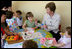 Mrs. Laura Bush helps a youngster blow bubbles at the Bethany House Orphanage Sunday, June 10, 2007, in Tirana, Albania. The orphanage is overseen by Bethany Christian Services of Michigan, and has been active in Albania since 1991.