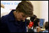 Mrs. Laura Bush reads with a child at the opening of the American Children's Corner at Sofia City Library Monday, June 11, 2007, in Sofia. Mrs. Bush said, "The books in this American Corner tell the story of the United States, describing my country's history, culture and diverse society. In these books, children in Sofia can discover literature that children in the United States enjoy."