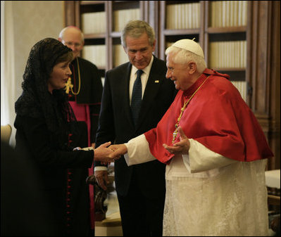 As President George W. Bush looks on, Mrs. Laura Bush shakes the hand of Pope Benedict XVI Saturday, June 9, 2007, during their visit to The Vatican in Rome.