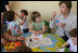 Mrs. Laura Bush blows bubbles for youngsters at the Bethany House Orphanage Sunday, June 10, 2007, in Tirana, Albania. The orphanage is overseen by Bethany Christian Services in Michigan, and has been active in Albania since 1991.