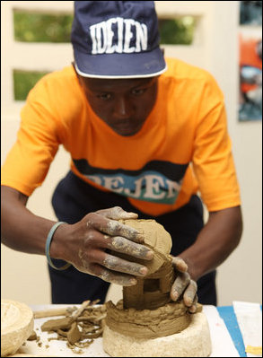 A student works on a sculpture Thursday, March 13, 2008, during Mrs. Laura Bush's visit to the IDEJEN educational program at the College de St. Martin Tours, in Port-au-Prine, Haiti.