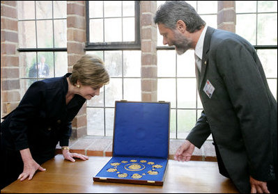 Mrs. Laura Bush is shown jewelry artifacts on her tour of the City of Stralsund Archives in Stralsund, Germany, Thursday, July 13, 2006, by Dr. Andreas Gruger, director of the Stralsund Museum of Cultural History.