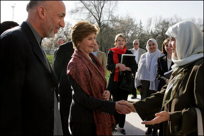 Afghan President Hamid Karzai introduces his wife, Dr. Karzai, to Laura Bush outside the presidential residence in Kabul, Afghanistan, Wednesday, March 30, 2005.