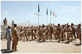 Mrs. Laura Bush is greeted Sunday, June 8, 2008, by New Zealand troops performing a traditional warrior's dance at the Bamiyan Provincial Reconstruction Team Base in Afghanistan's Bamiyan province. Standing with her is Major Justin de la Haye.