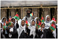 Future students of the Ayenda Learning Center wave flags and greet Mrs. Laura Bush during her visit to the construction site of the Ayenda Learning Center Sunday, June 8, 2008, in Bamiyan, Afghanistan.