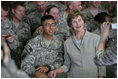 Mrs. Laura Bush poses for a photo with a US soldier during her visit to Bagram Air Force Base Sunday, June 8, 2008, in Bagram, Afghanistan.