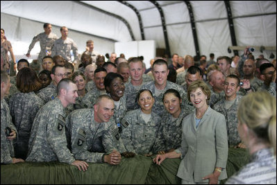 Mrs. Laura Bush poses for a photo with US troops during her visit to Bagram Air Force Base Sunday, June 8, 2008, in Bagram, Afghanistan.