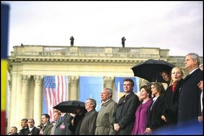 Laura Bush stands with Romanian Olympic gymnast Nadia Comanici, to her right, and Romanian Prime Minister Adrian Nastase during President Bush's speech before thousands of Romanians at the Piata Revolutiei in Bucharest, Romania. 