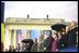 Laura Bush stands with Romanian Olympic gymnast Nadia Comanici, to her right, and Romanian Prime Minister Adrian Nastase during President Bush's speech before thousands of Romanians at the Piata Revolutiei in Bucharest, Romania. 