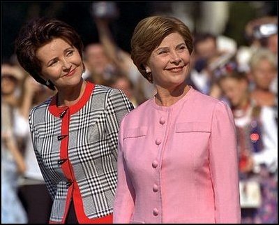 Mrs. Bush and Mrs. Kwasniewska stand together during the South Lawn ceremony at which the national anthems for both countries were performed and their husbands reviewed the troops.