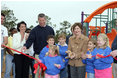 Laura Bush attends a ribbon cutting ceremony with football star Brett Favre and his wife, Deanna, left, at the Kaboom Playground, built at the Hancock North Central Elementary School in Kiln, Ms., Wednesday, Jan. 26, 2006, during a visit to the area ravaged by Hurricane Katrina.