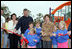 Laura Bush attends a ribbon cutting ceremony with football star Brett Favre and his wife, Deanna, left, at the Kaboom Playground, built at the Hancock North Central Elementary School in Kiln, Ms., Wednesday, Jan. 26, 2006, during a visit to the area ravaged by Hurricane Katrina.