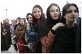 Women stand outside the U.S. Embassy in Kabul, Afghanistan Wednesday, March 1, 2006. President George W. Bush and Laura Bush made a surprise visit to the city and presided over a ceremonial ribbon-cutting at the embassy before continuing their trip to India.