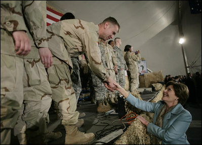 Mrs. Laura Bush greets U.S. and Coalition troops Wednesday, March 1, 2006, during a stopover at Bagram Air Base in Afghanistan, prior to the President and Mrs. Bush visiting India and Pakistan.