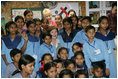 Mrs. Laura Bush poses for photos with teachers and students on her tour of Prayas, Thursday, March 2, 2006, in New Delhi, India.