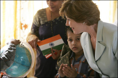 Mrs. Laura Bush watches as a child points out a place on a globe, Thursday, March 2, 2006, during her visit to Mother Teresa's Jeevan Jyoti (Light of Life) Home for Disabled Children in New Delhi, India.