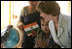 Mrs. Laura Bush watches as a child points out a place on a globe, Thursday, March 2, 2006, during her visit to Mother Teresa's Jeevan Jyoti (Light of Life) Home for Disabled Children in New Delhi, India.