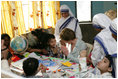 Mrs. Laura Bush is introduced to a young child, Thursday, March 2, 2006, during her visit to Mother Teresa's Jeevan Jyoti (Light of Life) Home for Disabled Children in New Delhi, India.