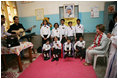 Mrs. Laura Bush listens to a children's choir, Thursday, March 2, 2006, during her visit to Mother Teresa's Jeevan Jyoti (Light of Life) Home for Disabled Children in New Delhi, India.