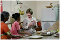 Mrs. Laura Bush visits a Home Science School Lab, Friday, March 3, 2006 at the Acharya N.G. Ranga Agricultural University in Hyderabad, India, viewing a demonstration on making guava cheese.