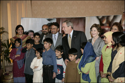 President George W. Bush and Pakistan President Perez Musharraf with Laura Bush and Mrs. Sehba Musharraf appear together Saturday, March 4, 2006 in Islamabad at a briefing to update the reconstruction and aid efforts for earthquake victims in regions of Pakistan.