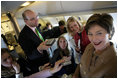 Laura Bush talks with members of the press aboard her plane en route to Turin, Italy, Friday, Feb. 10, 2006.