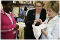 Laura Bush and U.S. Education Secretary Margaret Spellings meet newborn Iriella Johnson and her mother Irene Johnson, Thursday, Sept. 8, 2005, one of the many families displaced from New Orleans during Hurricane Katrina, during a visit to the Goodman Oaks Church of Christ in Southaven, Miss. The Goodman Oaks Church of Christ was one of the first shelters established in Mississippi when Hurricane Katrina hit the Gulf Coast on August 29, 2005.