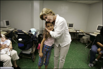 First Lady Laura Bush hugs a young girl displaced by Hurricane Katrina during her visit Friday, Sept. 2, 2005, to the Cajundome at the University of Louisiana in Lafayette.  "Some things are working very, very well in Louisiana," Mrs. Bush said.  "And certainly this center is one of those..."