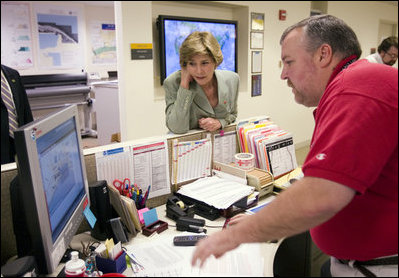 First Lady Laura Bush gets an update on the situation of efforts to help people in the aftermath of hurricane Katrina during a visit of Red Cross headquarters with President George W. Bush on Sunday September 4, 2005.