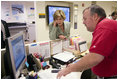 First Lady Laura Bush gets an update on the situation of efforts to help people in the aftermath of hurricane Katrina during a visit of Red Cross headquarters with President George W. Bush on Sunday September 4, 2005.