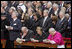 President George W. Bush and Laura Bush stand amidst mourners at funeral services Friday, April 8, 2005, for the late Pope John Paul II in St. Peter's Square.