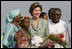 Mrs. Laura Bush stands with 10-year-old Aisha Garuba Sunday, Jan. 15, 2006, after she presented Mrs. Bush with flowers upon her arrival at Kotoka International Airport in Accra, Ghana. White House photo by Shealah Craighead