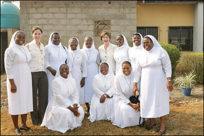 Laura Bush and her daughter Barbara Bush pose for a photo with some of the staff at St. Mary's Hospital, Wednesday, Jan. 18, 2006 in Gwagwalada, Nigeria.