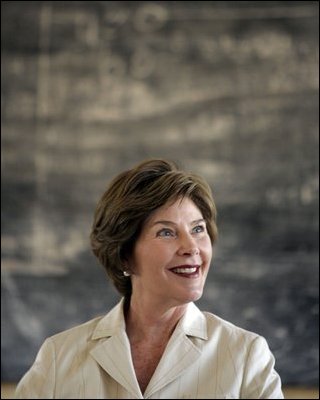 Mrs. Laura Bush smiles as she listens to a student at Model Secondary School Wednesday, Jan. 18, 2006, in Abuja, Nigeria. The visit came on the last of a four-day visit to West Africa.