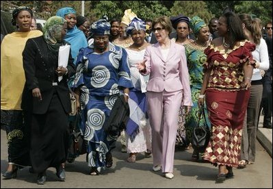 Laura Bush walks with members of the National Center for Women's Development in Abuja, Nigeria to the Women's Hall of Fame January 18, 2006.