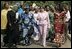 Laura Bush walks with members of the National Center for Women's Development in Abuja, Nigeria to the Women's Hall of Fame January 18, 2006.