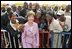 Laura Bush poses with U.S. Embassy workers and their family members, Wednesday, Jan. 18, 2006, during a stop at the U.S. Embassy in Abuja, Nigeria.