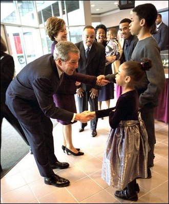 Greeting 6-year-old Natalie Jenkins, President George W. Bush and Laura Bush meet Pastor John K. Jenkins, Sr.'s family at the First Baptist Church of Glenarden in Landover, Md., Monday, Jan. 20, 2003. The church holds an annual service celebrating the legacy and life of Dr. Martin Luther King, Jr. White House photo by Eric Draper.