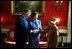 Laura Bush and Placido Domingo greet luncheon guests in the Red Room of the White House January 21, 2003. Mrs. Bush hosted a birthday luncheon in the Maestro's honor. White House photo Susan Sterner.